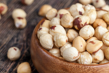 peeled and roasted hazelnuts on a wooden table