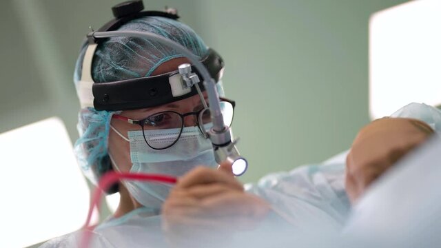 doctor is operating in modern hospital, qualified surgeon woman is performing endoscopic procedure