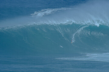 Sport photography. Jaws swell on International surfing event in Maui, Hawai 2021 December.