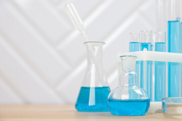 Laboratory glassware with blue liquid in a test tube. scientific laboratory flasks, droppers, Petri dishes, beakers and cylinders, laboratory equipment