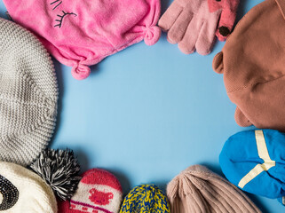 Knitted warm baby clothes. Multicolored socks, hats and gloves for girls and boys.