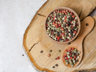 Obraz na płótnie Canvas Pepper mix. Black, red, green, white peppercorns spices, Mix of different peppers in a wooden spoon