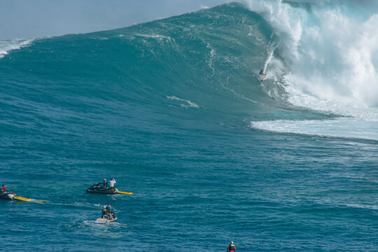 Sport photography. Jaws swell on International surfing event in Maui, Hawai 2021 December.