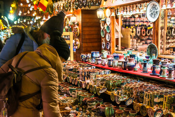 Two Female Tourists Looking And Buying Gifts At The Christmas Market In Bucharest, Romania.