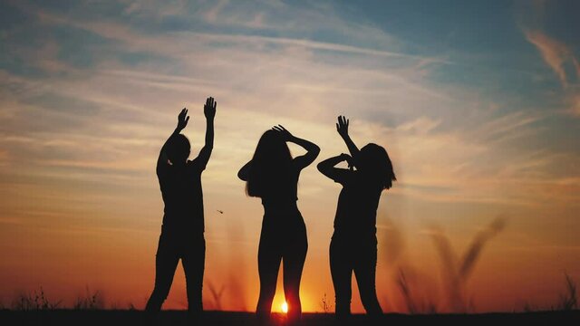 party in the park in nature. nightclub on open air dance concept. happy family a resting in nature travel fun. festival at night in the park. silhouette of a girl dancing in the evening at sunset