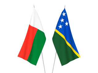 National fabric flags of Madagascar and Solomon Islands isolated on white background. 3d rendering illustration.