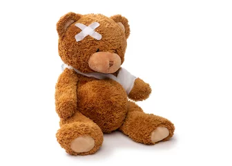Fotobehang medicine, healthcare and childhood concept - teddy bear toy with bandaged paw and patch on head on white background © Syda Productions
