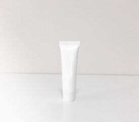 Beautiful tubes on a beautiful white table. No labels. For cosmetics.