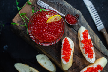 Red caviar on a dark background. Sandwiches with caviar