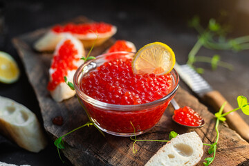 Red caviar on a dark background. Sandwiches with caviar