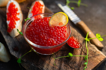 Red caviar on a dark background. Sandwiches with caviar