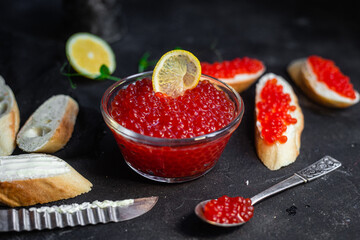 Red caviar on a dark background. Sandwiches with caviar