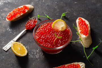 Red caviar on a dark background. Sandwiches with caviar