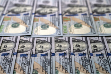 Background with banknotes of american 100 dollars bills. Selective focus