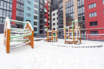 Fototapeta na wymiar Children's playground covered with snow in winter