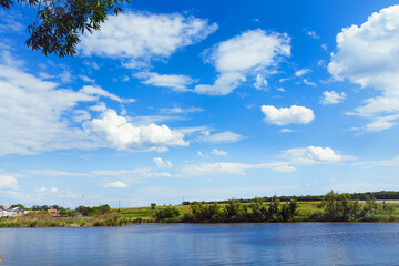 Landscape with clouds in blue sky over river