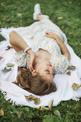 Portrait of young woman with physical disability in stylish summer dress smiling sincerely in...
