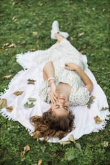 Portrait of young woman with physical disability in stylish summer dress smiling sincerely in...
