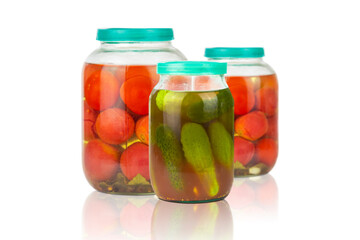 Canned tomatoes and cucumbers in a glass jar on a white background, the concept of canning, fermentation