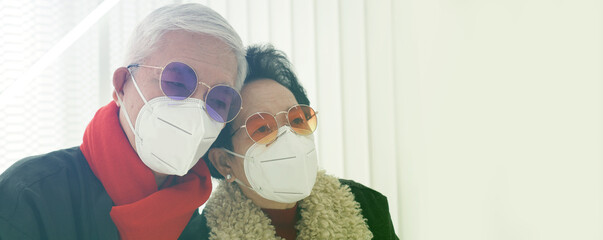 Asian senior elderly couple worry depress about Covid-19 pandemic in Winter with Omicron never...