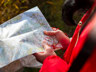 Female hiker using map and compass