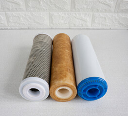 Used cartridges for water purification. Three cartridges for a household reverse osmosis system for water purification from mechanical impurities, chlorine and inorganic impurities.