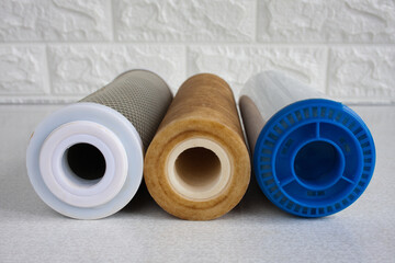 Used cartridges for water purification. Three cartridges for a household reverse osmosis system for water purification from mechanical impurities, chlorine and inorganic impurities. closeup