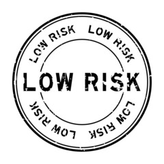 Grunge black low risk word round rubber seal stamp on white background