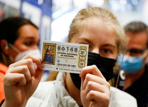 A young winner shows her prize-winning number for the first Christmas lottery prize, in Las Palmas de Gran Canaria