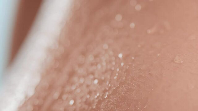 Extreme close-up shot of good-looking healthy pure clean flawless wet moving skin on pale blue background | Skin hydration concept