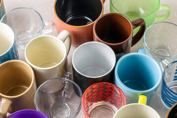 empty mugs of different shapes and sizes on the table