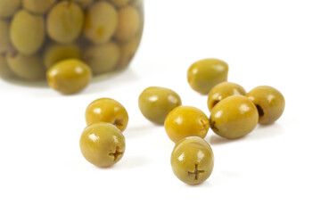 Green olives on a white background. Olives on a white background. Top view. Pitted green olives on white background. Close up.
