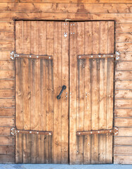 Old wooden gate with metal hinges