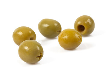 Green olives on a white background. Olives on a white background. Top view. Pitted green olives on white background. Close up.