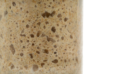 fresh rye sourdough on whole grain flour in glass jar, yeast-free leaven starter for healthy organic rustic bread. close up. Healthy eating.