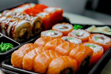 Japanese sushi food. Maki ands rolls with tuna, salmon, shrimp, crab and avocado. Top view of assorted sushi. Rainbow sushi roll, uramaki, hosomaki and nigiri.