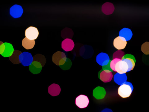 Landscape view of out of focus decoration color lights . Heptagon bokeh shapes wallpaper or background for texts, images and articles, blank space with blurred background.Christmas light.
