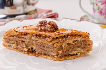 traditional oriental sweetness - baklava with walnuts on a white plate
