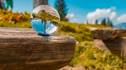 Crystal ball alpine summer landscape shot at the famous Purtschellerhaus near Berchtesgaden,...