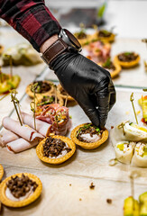 Chef hand is in process of Preparing catering food