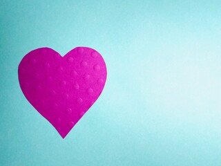 pink heart on green background  with texture dots on heart with copy space