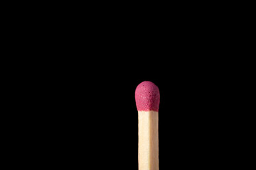 Macro shot of one match isolated on black background