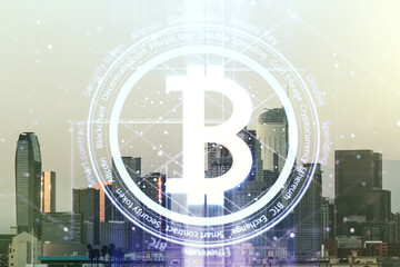 Naklejka premium Double exposure of creative Bitcoin symbol hologram on Los Angeles city skyscrapers background. Cryptocurrency concept