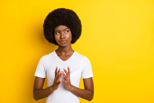 Photo of attractive nice afro american young dreamy woman look empty space evil plan isolated on yellow color background