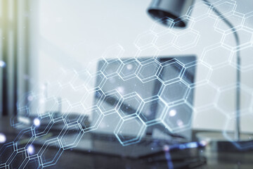Creative concept of wireless technology with hexagon hologram on modern laptop background. Big data...