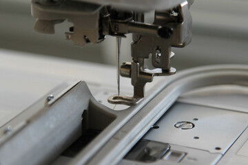 Closeup view of needle and foot of sewing machine.