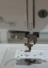 Closeup view of needle and foot of sewing machine.