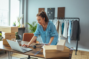 Women, owener of small business packing product in boxes, preparing it for delivery. Working woman...