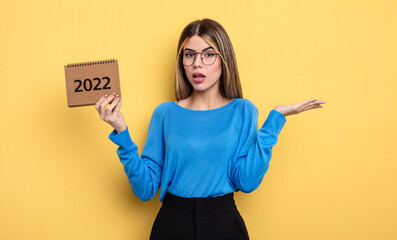 pretty woman feeling puzzled and confused and doubting. 2022 calendar concept