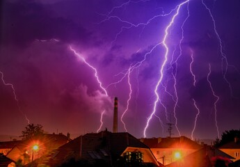 Fototapeta na wymiar Chimney in hugs lightning during the summer night
